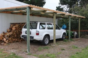 A carport made using lathe-turned poles.